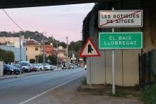 Pla general del doble rètol de Castelldefels que indica la fi del nucli les Botigues de Sitges i l'inici del Baix Llobregat. Imatge del 28 de març de 2018