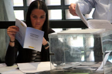 Una membre d'una mesa electoral de Barcelona repassa el reglament i les instruccions a seguir en les eleccions municipals