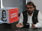 Pla mig del secretari general d'UGT a Catalunya, Camil Ros, amb un cartell de 'Llibertat Dolors' al fons, durant l'entrevista amb l'ACN